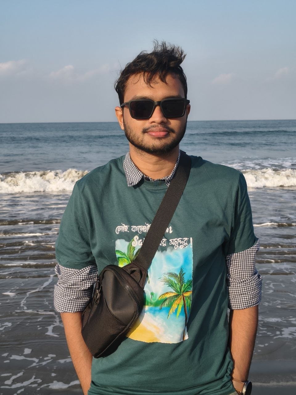 Souvik standing beside the sea